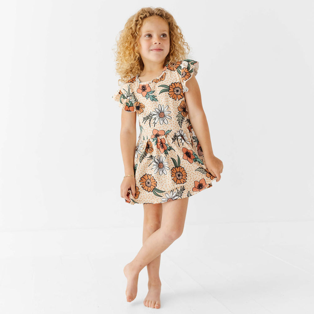 Young girl wearing a floral dress on a white background