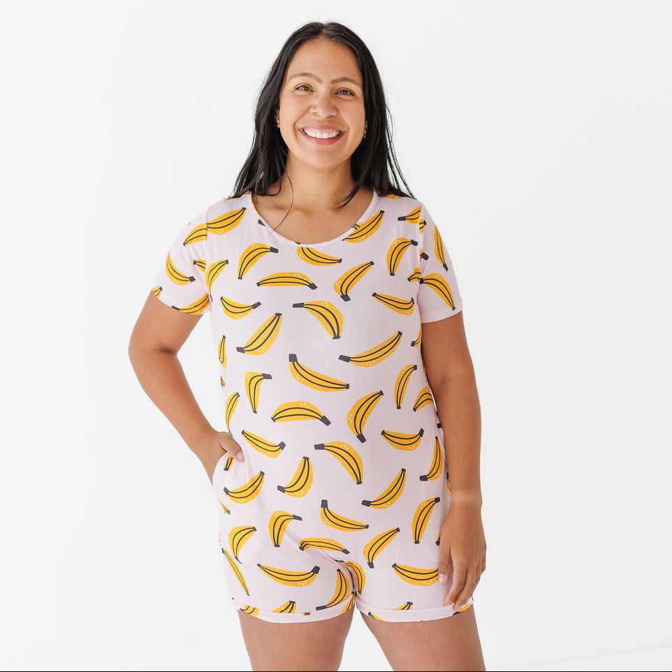 Woman wearing a white romper with yellow banana patterns on a white background