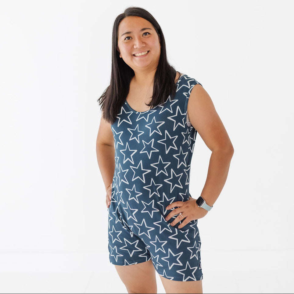 Woman wearing a blue dress with white star pattern on a white background