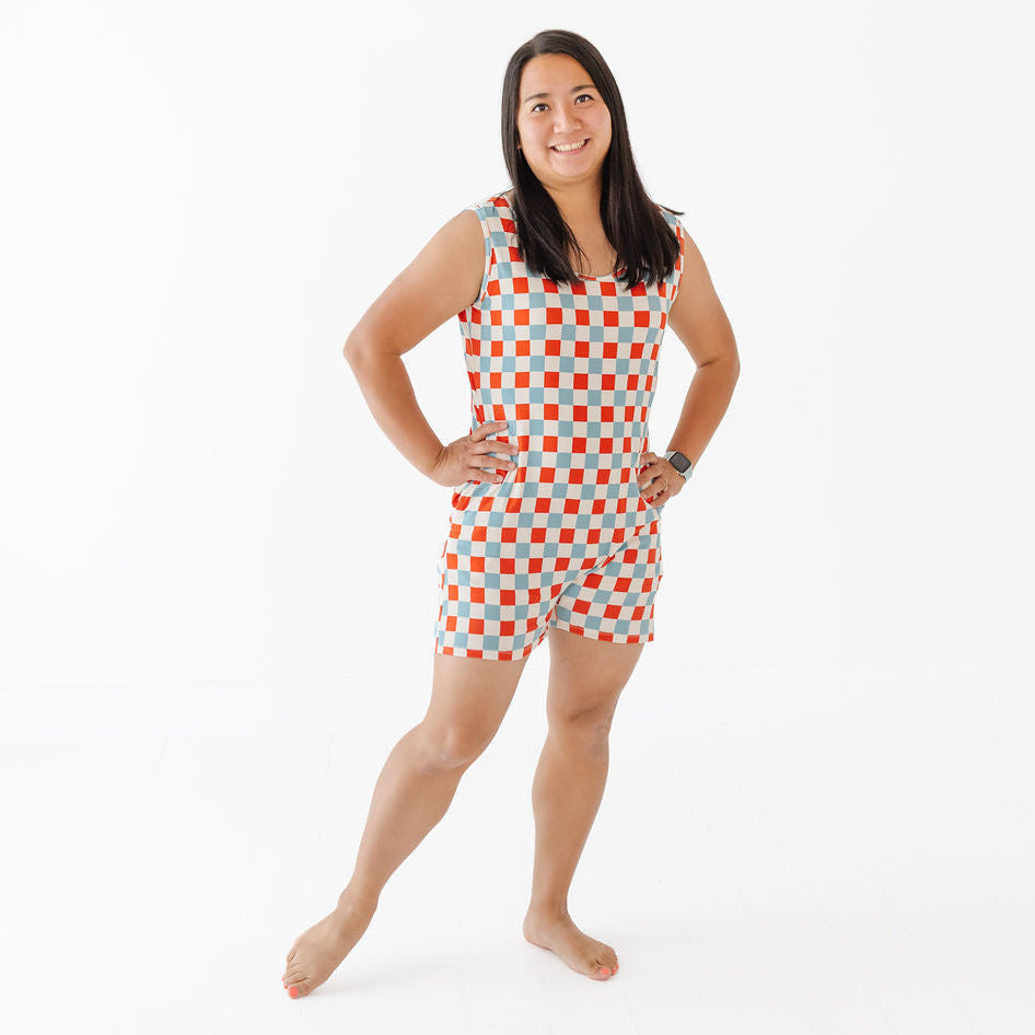 Woman wearing a red and white checkered romper on a white background