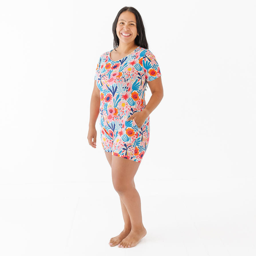 Woman wearing a colorful floral dress on a white background