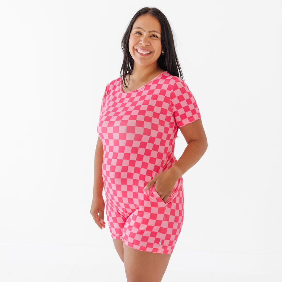 Woman wearing a pink checkered dress on a white background