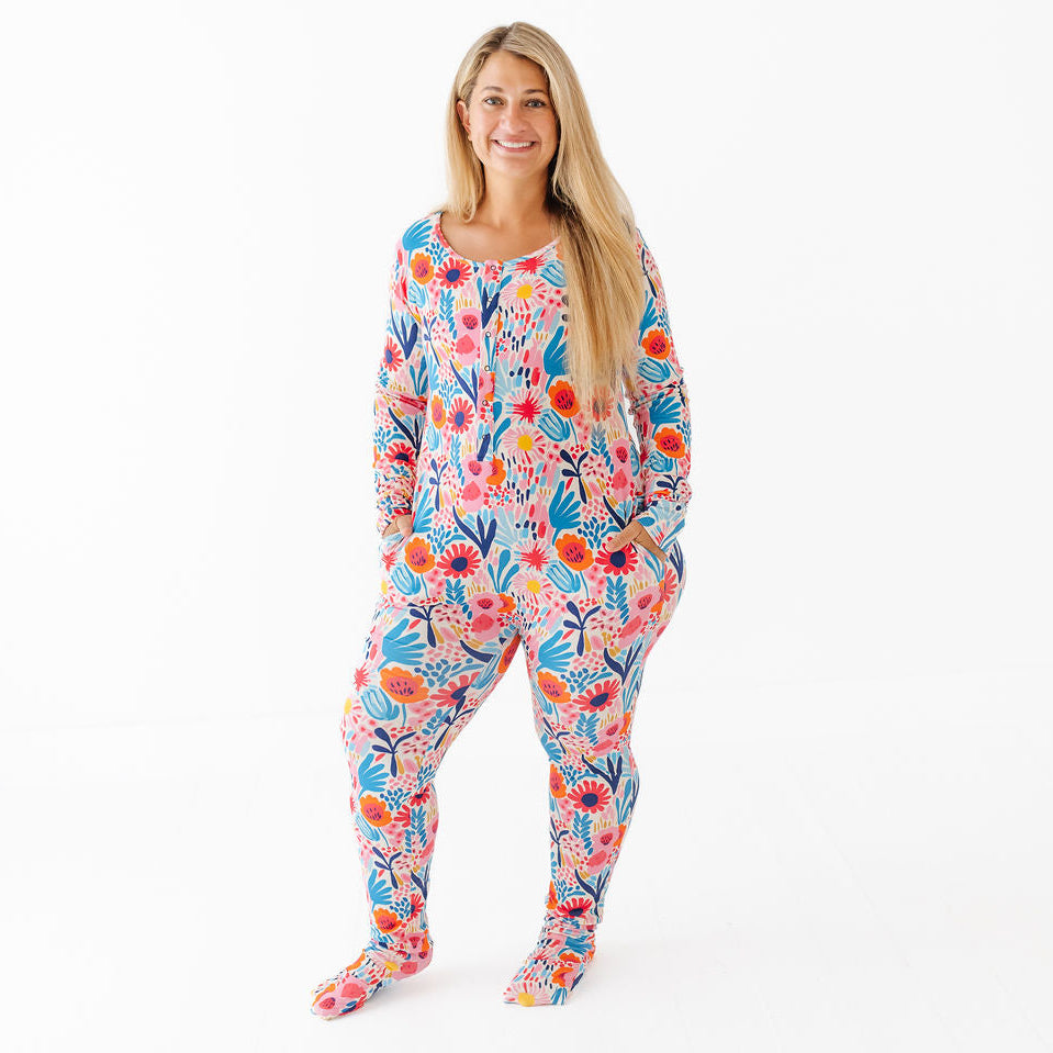 Woman wearing a colorful floral onesie on a white background