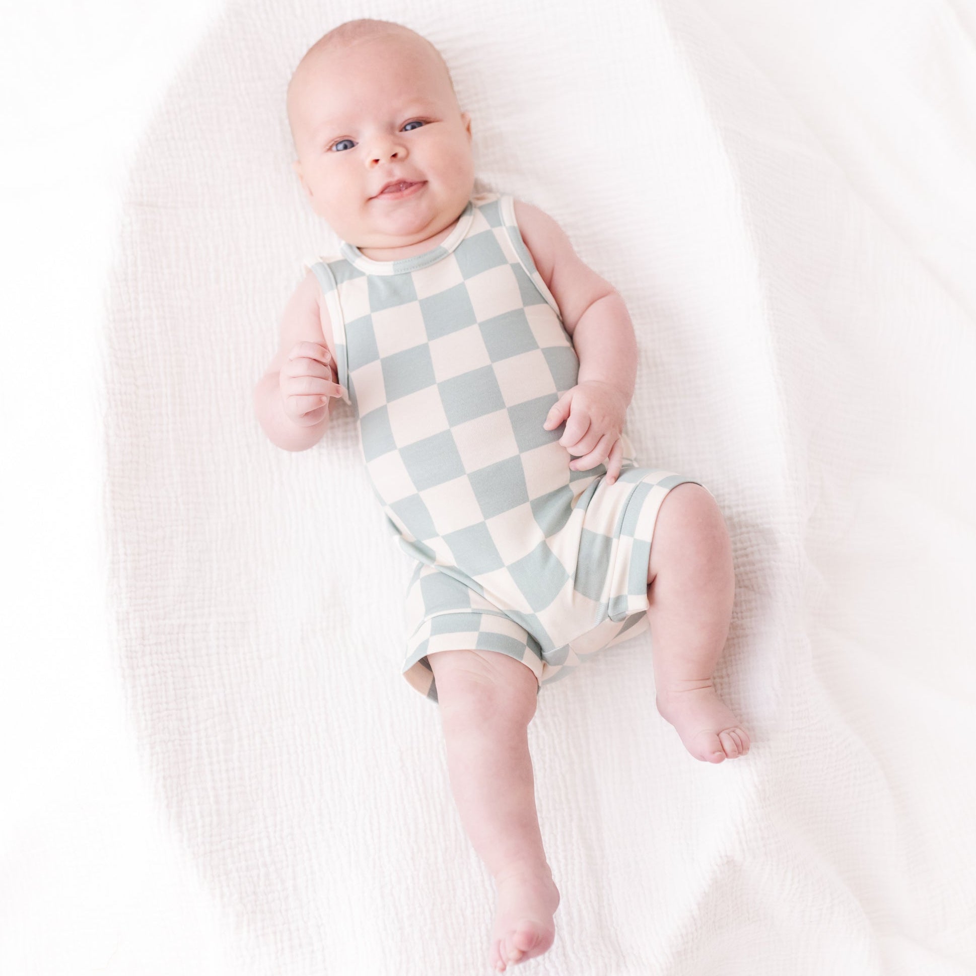 baby wearing blue checker onsie 

